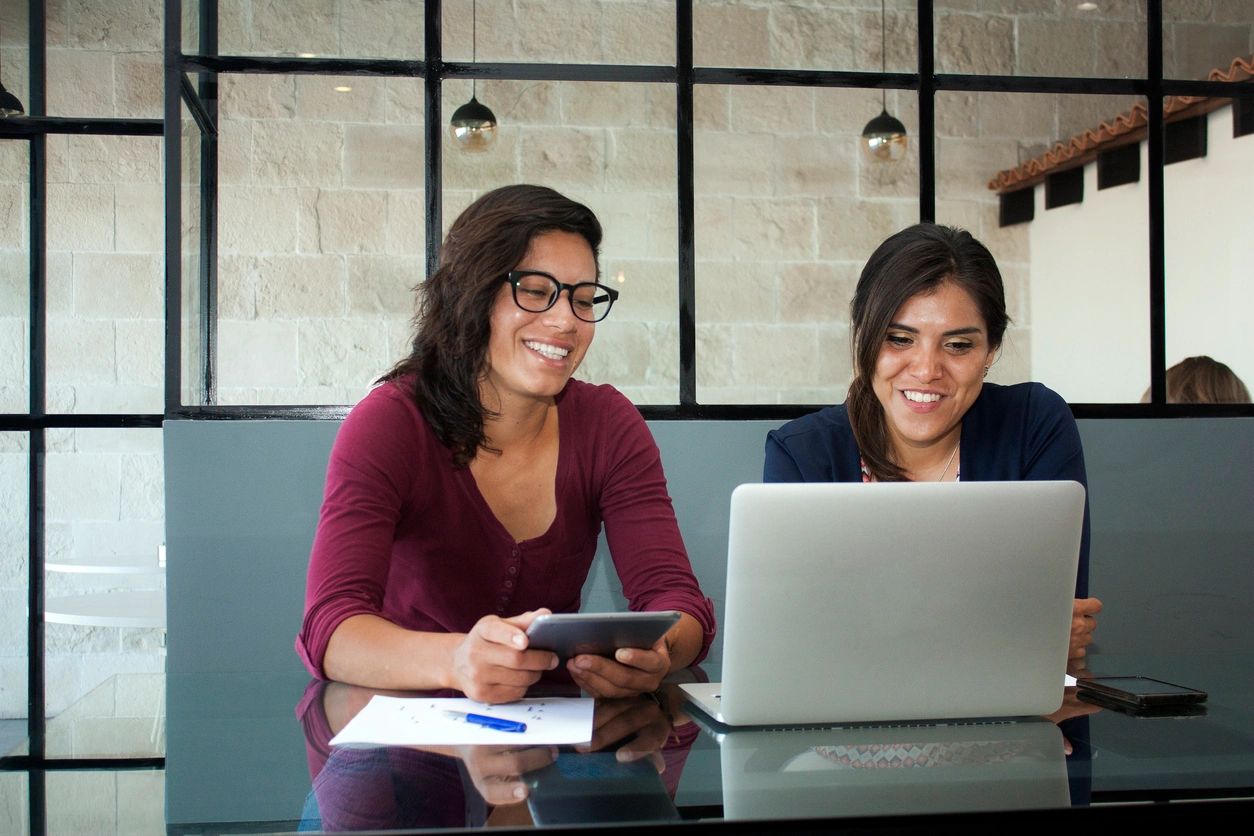 two women looking at a computer